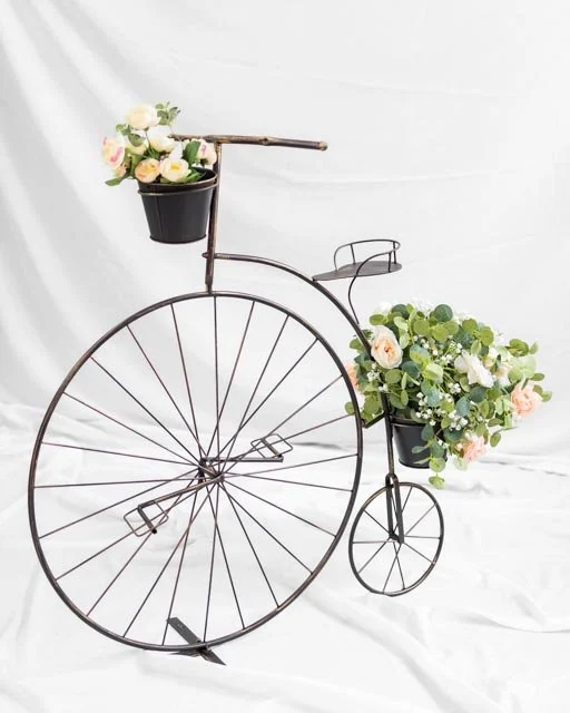Decorative metal bicycle with floral baskets