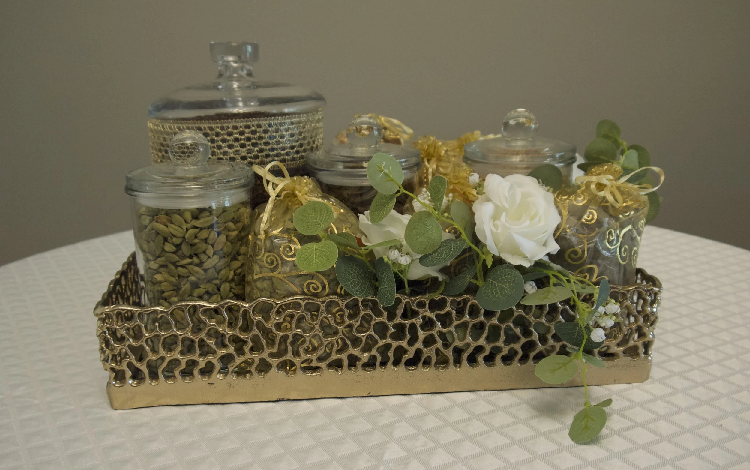 Decorative tray with glass jars and faux greenery